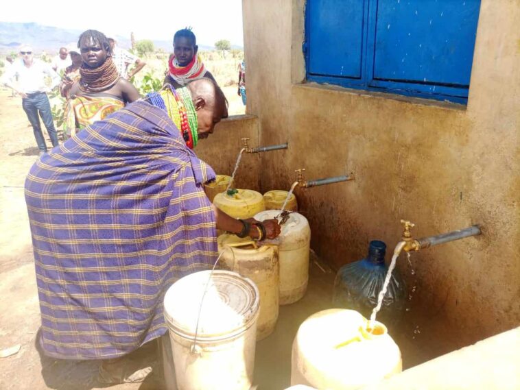 A woman fetching water from a water kiosk. (KDRDIP project ), PHOTO COURTESY DEBRA LOCHA