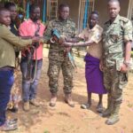 warriors hand over the guns to the UPDF in Moroto army barracks on Saturday, - Screenshot ; COURTESY