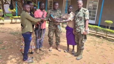 warriors hand over the guns to the UPDF in Moroto army barracks on Saturday, - Screenshot ; COURTESY